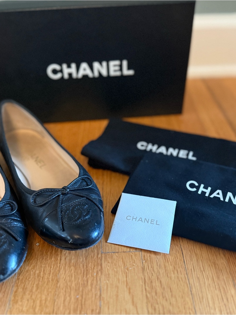 CHANEL Black Leather Ballet Flats with Bow and Embossed CC